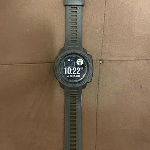 Garmin Instinct GPS watch with manual